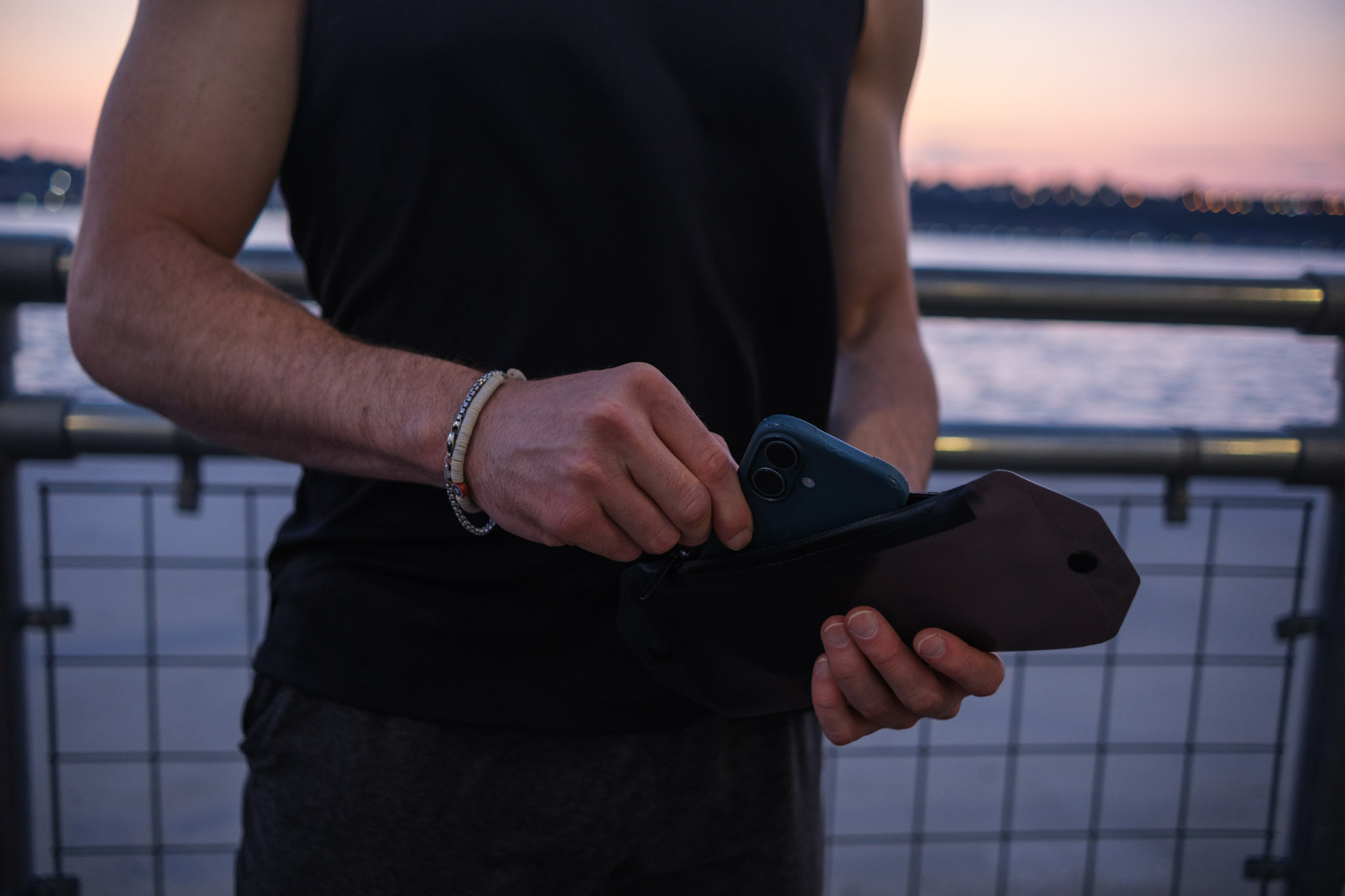 Runner sliding a phone into the SwapBelt pouch